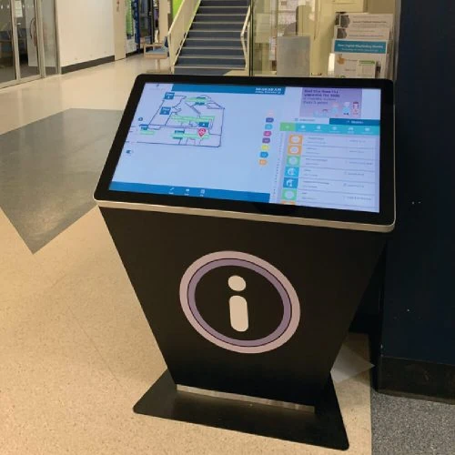 Standing touch screen kiosk inside a health facility
